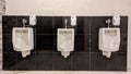 Three neatly installed urinals