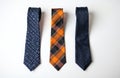 Three neckties with different patterns on white background. Ties made of silk textile with various designs. One tie white symbols Royalty Free Stock Photo