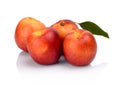 Three nectarines with leaf isolated on white Royalty Free Stock Photo