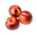 Three nectarines on a white isolated background. Top view. Close-up.