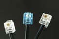 Three telephone cables with connector on black Royalty Free Stock Photo