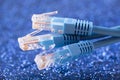 Three network cables over blue sparkles background Royalty Free Stock Photo