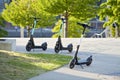 Three new electric scooter parking in the city by sunlight