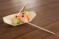 Three nigiri sushi served with chopsticks in wooden boat plate Royalty Free Stock Photo