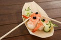 Three nigiri sushi served with chopsticks in wooden boat plate Royalty Free Stock Photo
