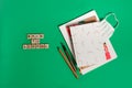 Three notebooks on green background with ink pen and copy spaces. Journal writing and note taking concept Royalty Free Stock Photo