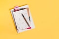 Three notebooks on yellow background with ink pen and copy spaces. Royalty Free Stock Photo