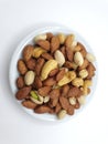 three nuts on top of the bowl,almonds,pistachio and cashew