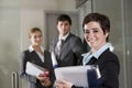 Three office workers at door of boardroom