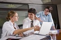 Three office workers meeting in boardroom