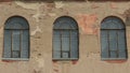 Three old arched windows of building