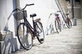 Three old bicycles against a marble wall Tuscany - Italy