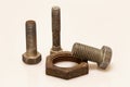 Three old bolts and a rusty nut Royalty Free Stock Photo