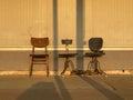 Three old chairs on street at sunset. Royalty Free Stock Photo