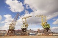 Three old cranes standing by the Odra River in Szczecin, city la Royalty Free Stock Photo