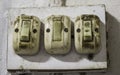 Three old and dirty light bulb switch