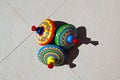 Three old fashioned circus design tin spinning tops lie on the ground Royalty Free Stock Photo
