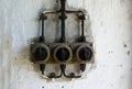 Three old industrial electric plug and switch on the vintage wall Royalty Free Stock Photo