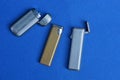 old metal lighters on a blue table Royalty Free Stock Photo