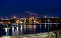 Illuminated colorful old port cranes on river Odra boulevard in Szczecin at night. Poland