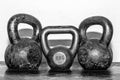 Three old and rusty KettleBells on the gym floor