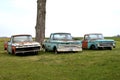 Three old rusty pickups