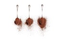 Three old silver spoons with ground coffee on a white background Royalty Free Stock Photo