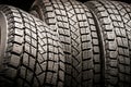 Three old used winter tires. Close-up on a black background