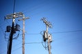 Three old utility poles against clear blue sky Royalty Free Stock Photo