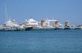 The Three Old Windmills on the Harbor are Surrounded by Cruise Ships, Private Boats and Yachts on Rhodes, Greece Royalty Free Stock Photo