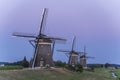 Three old windmills from the year 1672 in Stompwijk Molendriegang Stompwijk, the Netherlands just after sunset