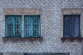 Three old windows on the gray brick wall of the house Royalty Free Stock Photo