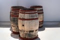 Three old wooden barrels staying near the wall. Santorini island, Greece Royalty Free Stock Photo