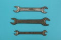 Three old wrenches on a blue background Royalty Free Stock Photo