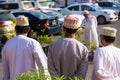 Three Omani men shoulders in traditional clothes with dishdasha and kuma Royalty Free Stock Photo