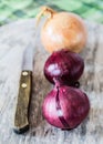 Three onions on cutting board.