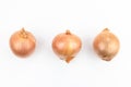 Three onions isolated on white background, top view. Flat lay Royalty Free Stock Photo