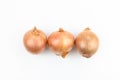 Three onions isolated on white background. Top view. Flat lay Royalty Free Stock Photo