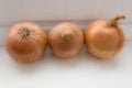 Three onions on the white background Royalty Free Stock Photo