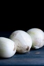 Three onions on a wooden table Royalty Free Stock Photo