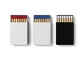 Three open matchboxes with red blue and white tipped matches isolated on white background Royalty Free Stock Photo