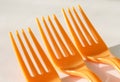 Three orange forks