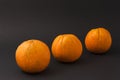 Three oranges on a black background Royalty Free Stock Photo