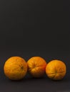 Three oranges on a black background Royalty Free Stock Photo