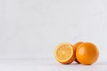 Three oranges and slice on white wood table and plaster background. Royalty Free Stock Photo