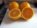 Three Oranges wth One Sliced in Half Royalty Free Stock Photo