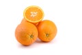 Three oranthree oranges, whole and cut with splashes of juice close-up on a white background, horizontal viewges close-up on a Royalty Free Stock Photo