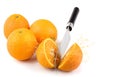 Three oranthree oranges, whole and cut with splashes of juice close-up on a white background, horizontal viewges close-up on a Royalty Free Stock Photo