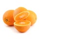 Three oranthree oranges, whole and cut with splashes of juice close-up on a white background, horizontal viewges close-up on a Royalty Free Stock Photo