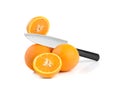 Three oranthree oranges, whole and cut with splashes of juice close-up on a white background, horizontal viewges close-up on a Royalty Free Stock Photo